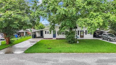 View of front of house featuring a carport and driveway