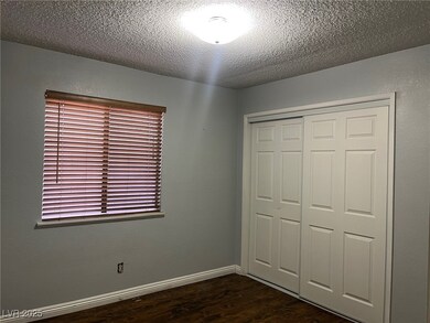 Unfurnished bedroom featuring dark wood-style floo