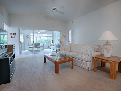 GREAT ROOM LOOKS RIGHT OUT TO THE ENCLOSED FLORIDA ROOM WITH A WOODED VIEW!