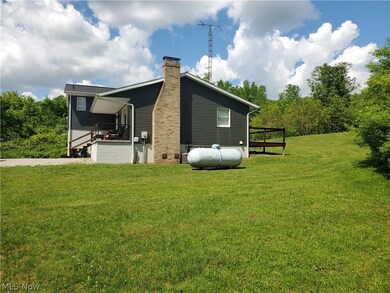 View of side of home with a lawn