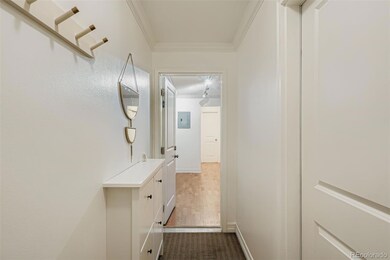 Hallway into unit, with laundry room on the right.