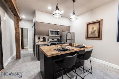 Kitchen with butcher block counters, appliances wi