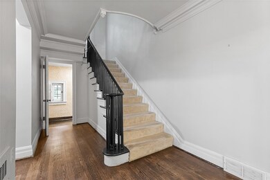 Gracious boxed staircase takes you to the second f
