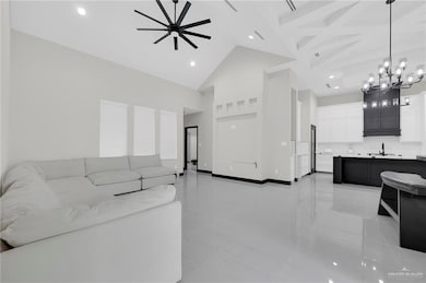 Living area with high vaulted ceiling, a chandelier, recessed lighting, a ceiling fan, and light tile patterned floors