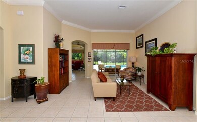 Living room toward large pool deck through sliders