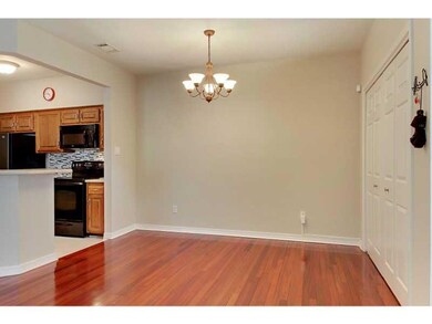 Photo. Dining area has wood floors and storage spa