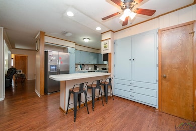 Kitchen with wood finished floors, ornamental mold
