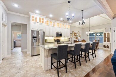GORGEOUS kitchen with large island & abundant cabinets also has walk-in pantry & coffee bar.