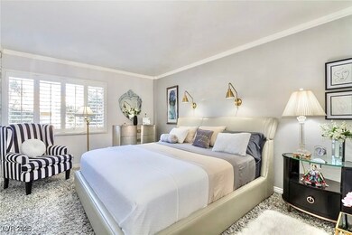 Carpeted bedroom with ornamental molding and baseb