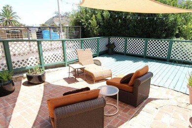 Wood deck off of brick patio