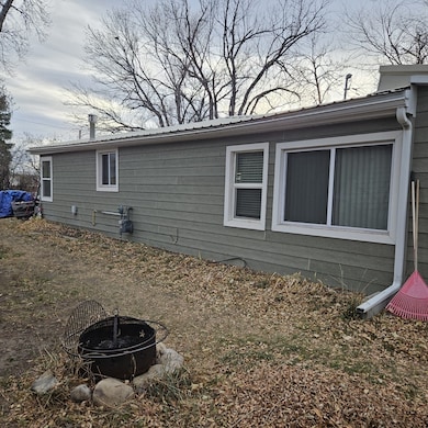 View of property exterior featuring a fire pit