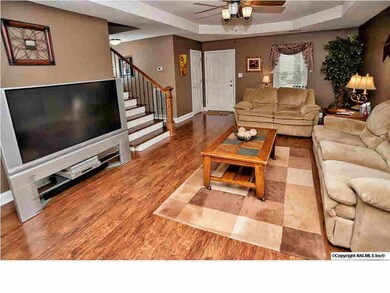 Trey ceilings and a beautiful staircase are also in the family room.