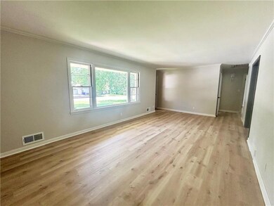 Unfurnished room featuring ornamental molding and light wood-style floors