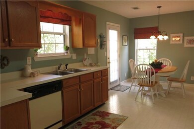Maple shelving and stainless steel sink are featured.