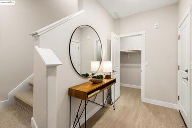 Hallway featuring light wood-style flooring and stairway