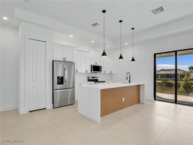 Kitchen featuring hanging light fixtures, stainles
