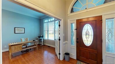 Double doors open to a spacious, light-filled offi