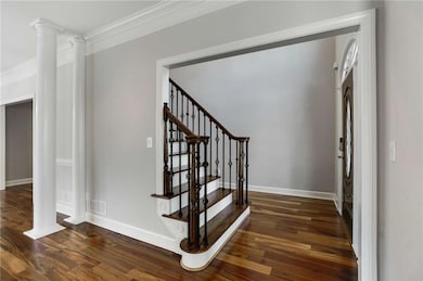 Staircase featuring visible vents, baseboards, orn