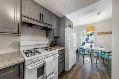 Kitchen with gray cabinetry, under cabinet range 