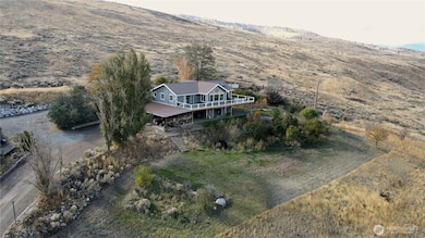 50 acres bordering Bonaparte Creek, boundary fencing and pastures, with multiple outbuildings.