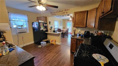 Kitchen featuring range, brown cabinets, light har