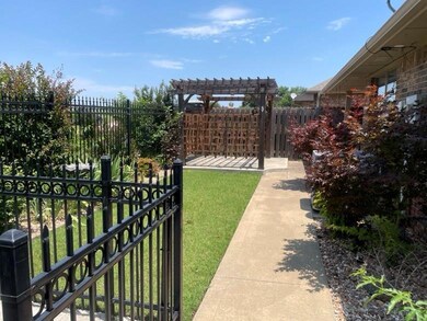 View of gate featuring a yard and a pergola