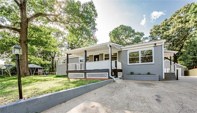 View of front facade with covered porch and a front lawn