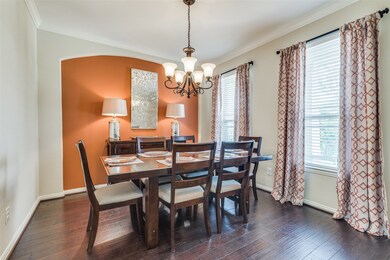 When you enter the home, immediately to the right is the formal dining with wood floors, an accent wall and drapes framing the windows!