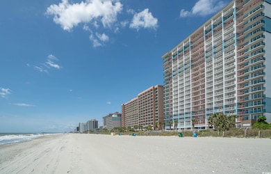 Exterior space with a beach view and a water view
