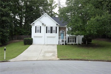 Split foyer home with concrete driveway and a garage