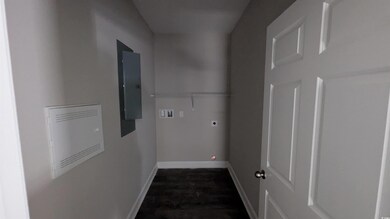 Laundry area featuring hookup for a washing machine, electric panel, electric dryer hookup, baseboards, and dark wood-style flooring