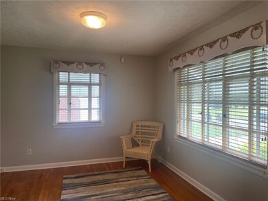 Living area featuring dark hardwood floors, a text