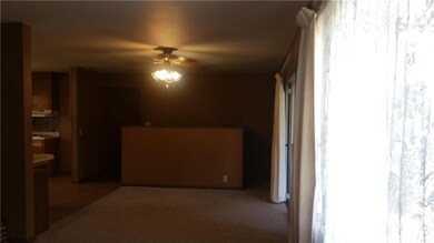 Dining area with half wall, stairs to the basement