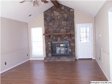 Great Room with moss rock fireplace, vaulted ceili