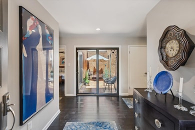ENTRY Offering Wide Plank Hardwood Flooring, Neutral Wall Tones, Recessed Lighting, and Side-Lite Windows That Fill the Space with Natural Light—Creating a Warm and Stylish Welcome to the Home