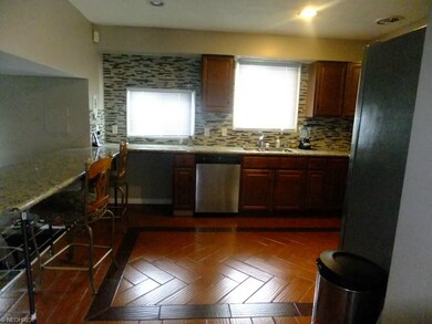 To the left is a view of the granite breakfast bar