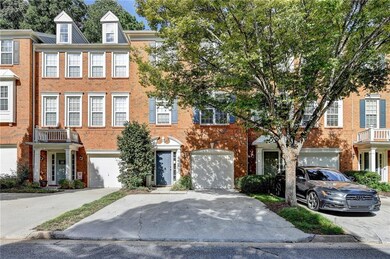 Colonial home with brick siding, driveway, and a balcony
