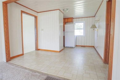 Spare room featuring baseboards and ornamental mol