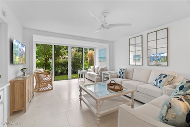 Tiled living room featuring ceiling fan