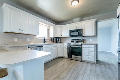 Kitchen with electric stove & stainless steel dish