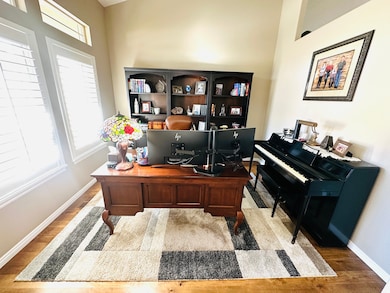 Office area with baseboards and light wood-style floors