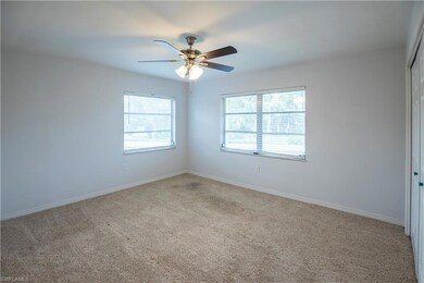 Empty room featuring carpet and a ceiling fan