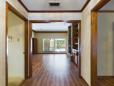 Hall with ornamental molding, dark wood-type floor