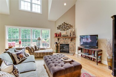 Family room/Den with two story ceilings - note the stone fireplace.