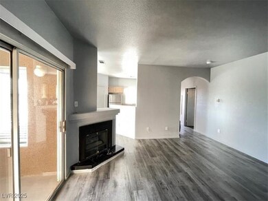 Unfurnished living room featuring arched walkways,