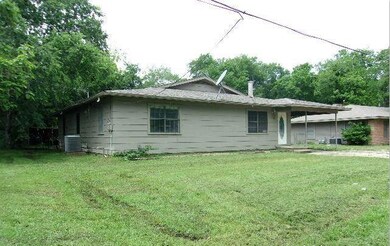Rear view of house featuring a yard and central AC
