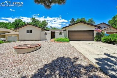Ranch-style house with concrete driveway, stucco siding, and a garage