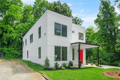 Modern home featuring a front yard and stucco siding