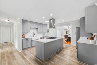 Kitchen with crown molding, a center island, islan