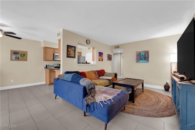 Living room with light tile patterned flooring, a